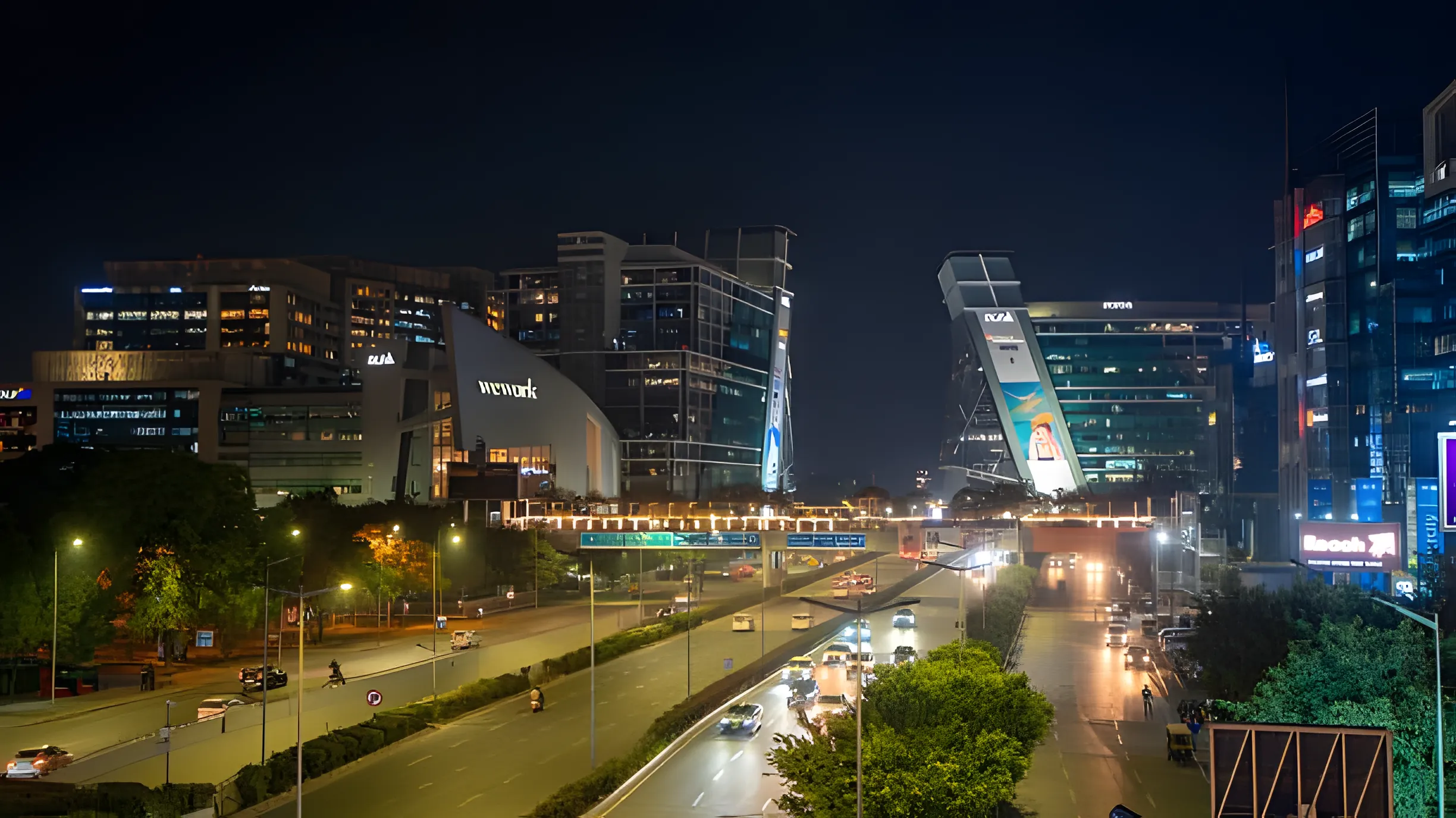 Cyber City, Gurgaon at night — the WeWork and DLF towers above the lit main road